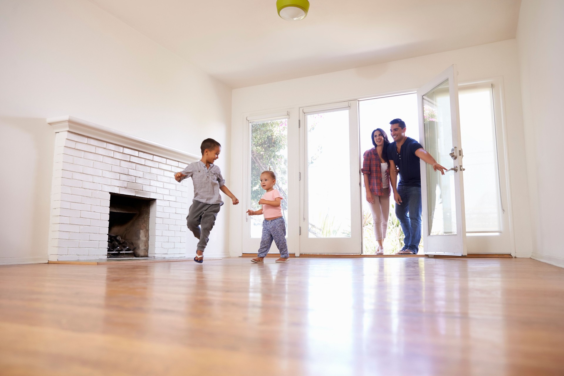 Excited Family Explore New Home On Moving Day