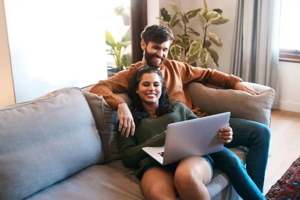 California home buyers reviewing mortgage preapproval information on a laptop